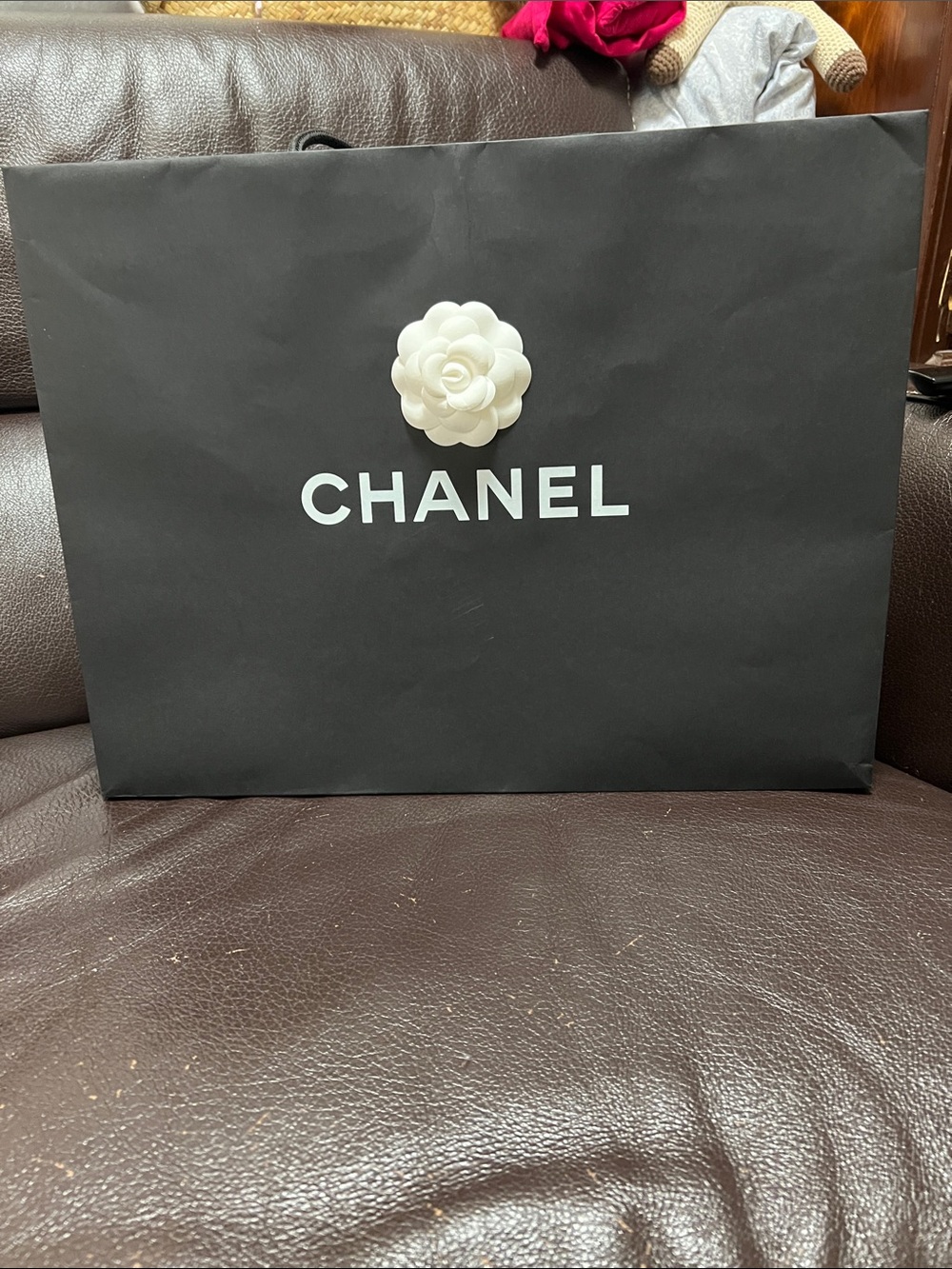 CHANEL Black Paper Shopping Bag with White Camellia Accent